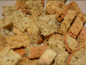 Close-up of gluten-free herb croutons showing toasted texture and seasoning throughout the bread