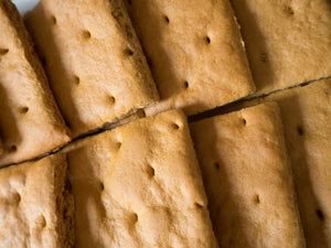 Close-up of gluten-free graham crackers from Outside The Breadbox, showing baked texture and perforated tops